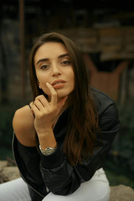 a beautiful young woman sitting on top of a rock, trending on pexels, photorealism, hand on her chin, leather jewelry, ana de armas portrait, beautiful iranian woman