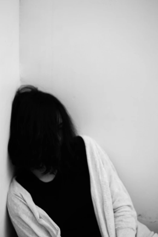 a black and white photo of a woman leaning against a wall, by Yuki Ogura, conceptual art, woman crying, whitebangsblackhair, faceless, feeling of disgust