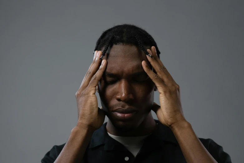 a man with his hands on his head, trending on pexels, ( ( dark skin ) ), lysergic, grey matter, center of picture