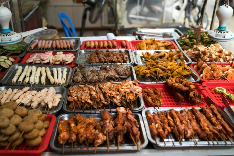 a table topped with lots of different types of food, a photo, by Matt Stewart, shutterstock, dau-al-set, wet market street, barbecue, square, gray