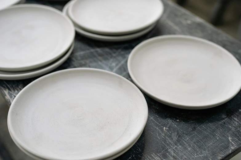 a group of white plates sitting on top of a table, inspired by Lewis Henry Meakin, wet clay, matte finish, 10k, blank