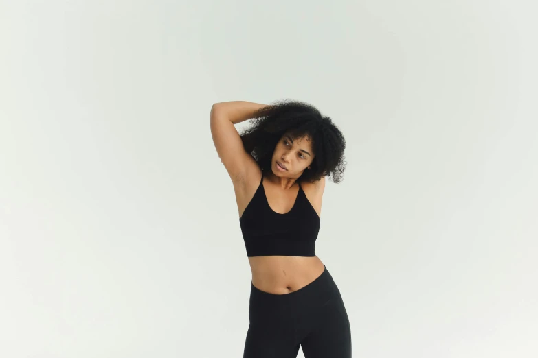 a woman in a black sports bra top and leggings, pexels contest winner, minimalism, ebony skin, health supporter, infp young woman, light skin