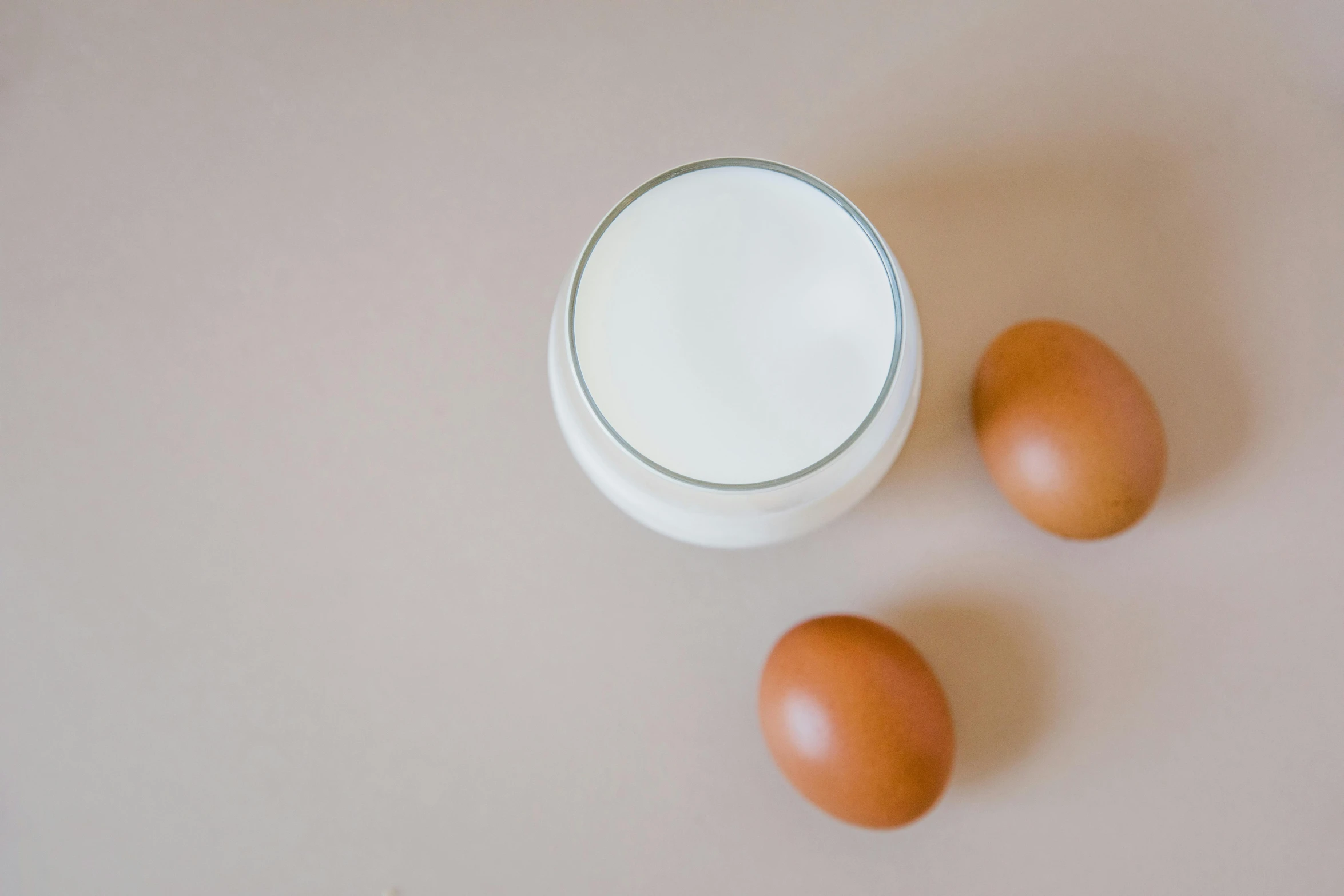 two eggs and a glass of milk on a table, by Jan Rustem, trending on unsplash, fan favorite, skincare, bao phan, farming