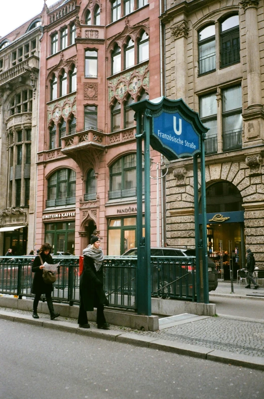 a group of people walking down a street next to tall buildings, by Konrad Witz, unsplash, art nouveau, subway station, swedish style, iu, private academy entrance