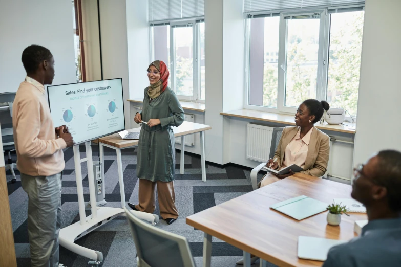 a woman giving a presentation to a group of people, trending on unsplash, hurufiyya, low quality photo, office furniture, african ameera al taweel, fan favorite