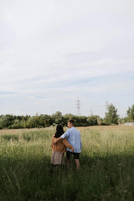 a man and a woman standing in a field, a picture, unsplash, happening, nature growing around the city, low quality photo, summer sky, lovers