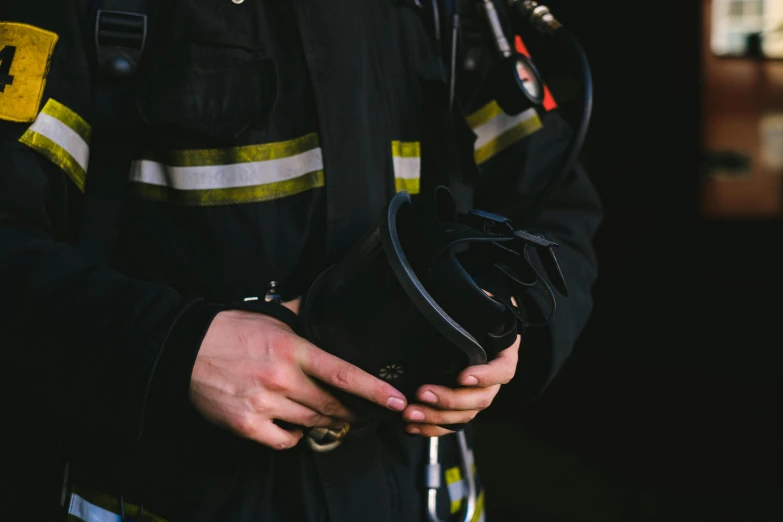 a close up of a person wearing a fireman uniform, a picture, by Adam Marczyński, pexels contest winner, holding a leather purse, hasselblad photo, 🦩🪐🐞👩🏻🦳, protective