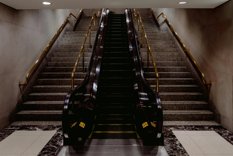 a couple of escalators sitting next to each other, inspired by Thomas Struth, unsplash, hyperrealism, brown, thumbnail, southdale center, black and gold