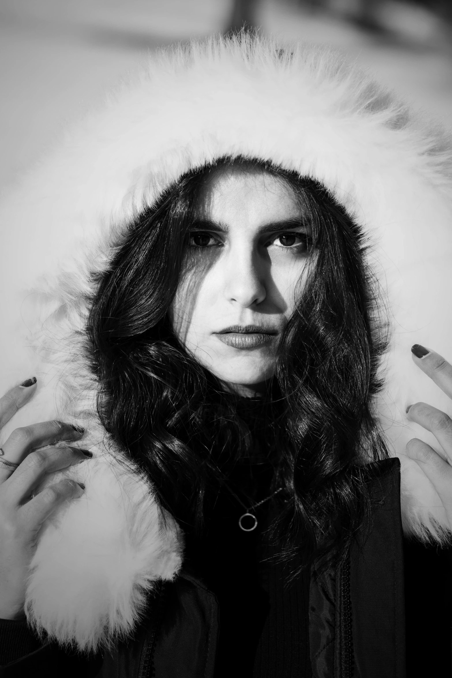 a black and white photo of a woman in a parka, inspired by Hannah Frank, antipodeans, maya ali as a wind mage, with a white nose, asher duran, ((portrait))