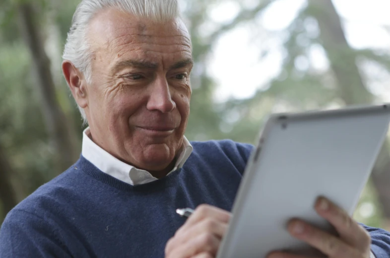 a close up of a person using a tablet, a portrait, by Julian Allen, older male, 15081959 21121991 01012000 4k, instagram post, looking at monitor