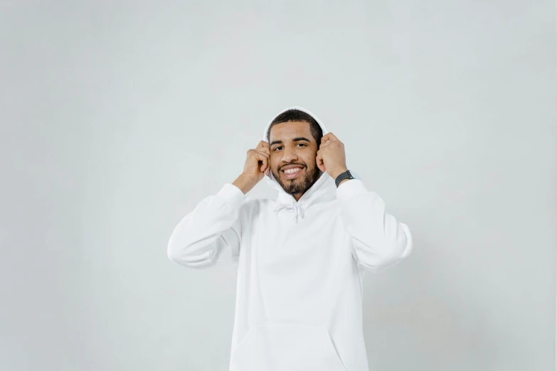 a man in a white robe talking on a cell phone, trending on pexels, happening, hoodie, drake, background image, white backdrop