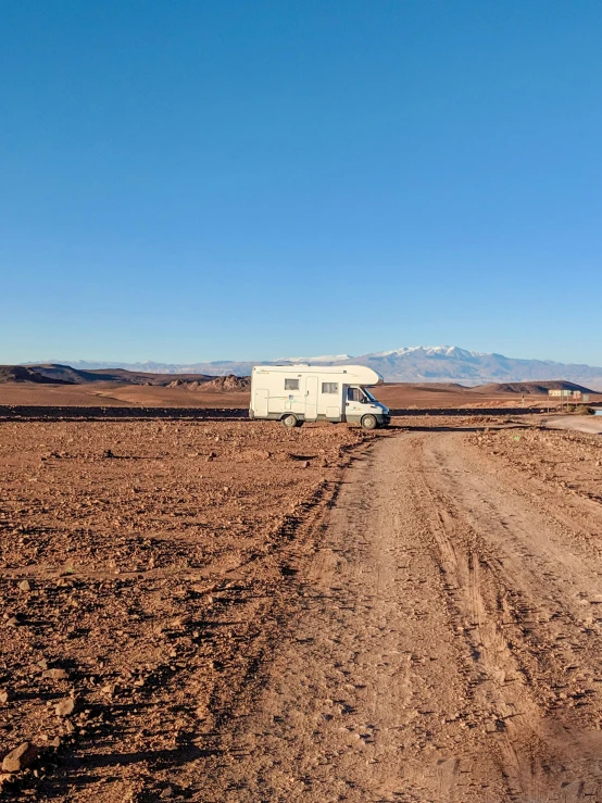 an rv parked on the side of a dirt road, by Julia Pishtar, les nabis, overlooking a desolate wasteland, 8 k. filling of the view, muddy ground, lots of diamonds unearthed