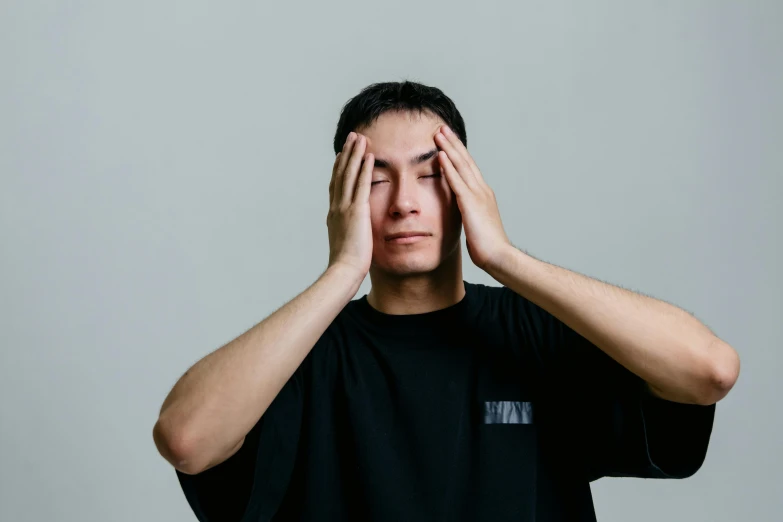 a man covering his eyes with his hands, unsplash, hyperrealism, hito steyerl, avatar image, asian human, greeting hand on head