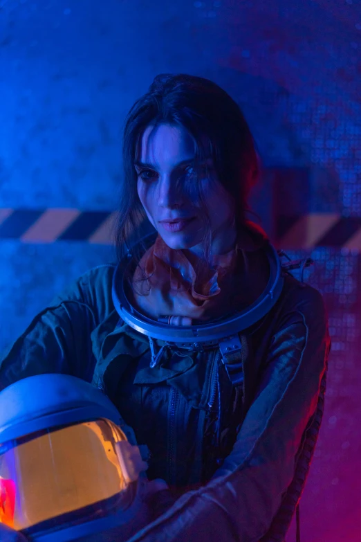 a woman in a space suit holding a helmet, inspired by Elsa Bleda, serial art, still from horror movie, kate bishop, set photo, juno promotional image