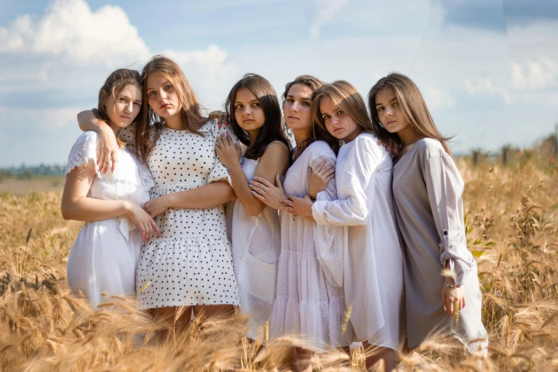a group of women standing next to each other in a field, by Adam Marczyński, pexels contest winner, renaissance, wearing white pajamas, teenager girl, brunette, modeled