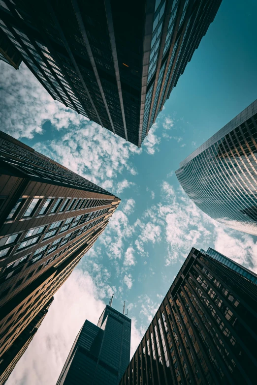 a group of tall buildings in a city, by Adam Rex, pexels contest winner, floating into the sky, looking upwards, sky - high view, parallax »