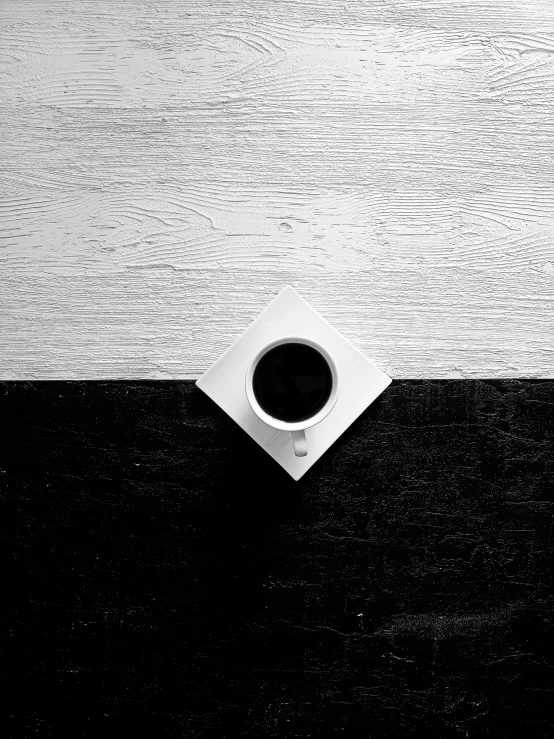 a cup of coffee sitting on top of a table, inspired by Arnold Newman, cinematic. by leng jun, sofya emelenko, square, anna nikonova