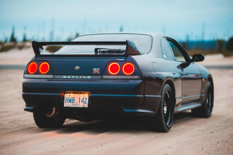 a black sports car parked on a dirt road, pexels contest winner, mingei, tail lights, in a modified nissan skyline r34, avatar image, super high resolution