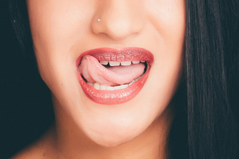 a woman with a tongue sticking out of her mouth, trending on pexels, hyperrealism, veins popping out, about to consume you, dermal implants, 2 7 years old