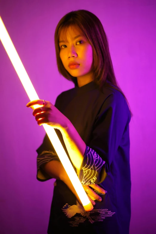 a woman holding a light saber in front of a purple background, inspired by Han Gan, unsplash, conceptual art, young asian girl, dramatic lighting !n-9, glowing aesthetic, medium portrait top light