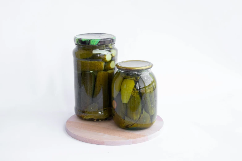 a couple of jars that have pickles in them, a picture, pexels, full body full height, circle, product view, vine