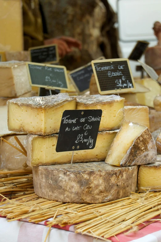 a table topped with lots of different types of cheese, renaissance, french village exterior, slide show, square, black