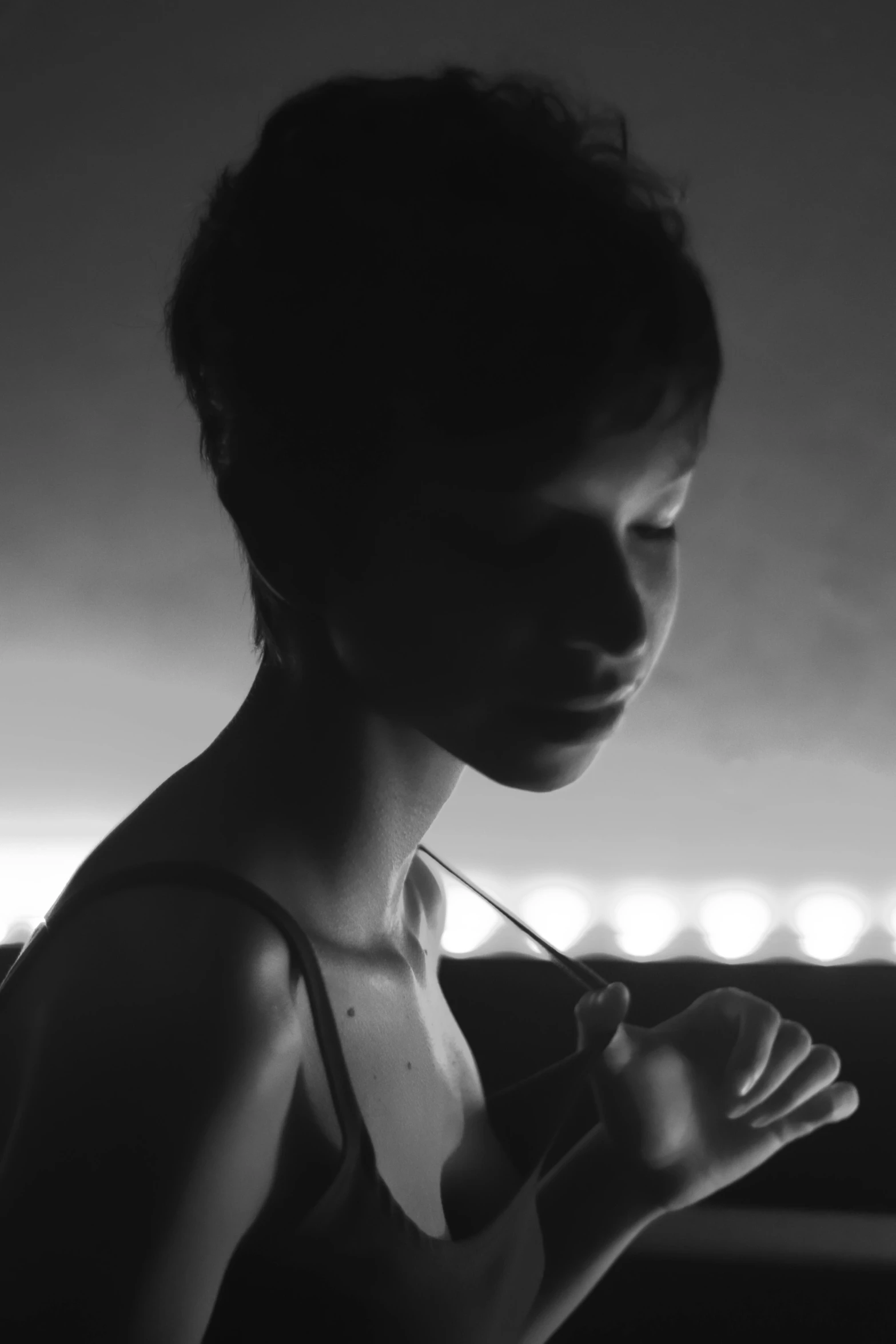 a black and white photo of a woman, inspired by Peter Lindbergh, pixie cut, still from a music video, very thin, (night)