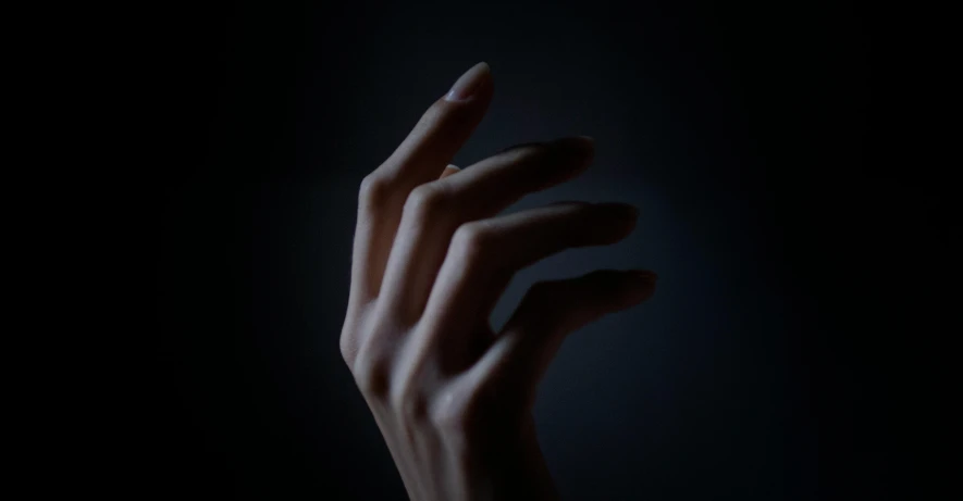 a woman's hand reaching for something in the dark, an album cover, inspired by Elsa Bleda, unsplash, hyperrealism, ignant, painted nails, [sculpture] and [hyperrealism], a pale skin