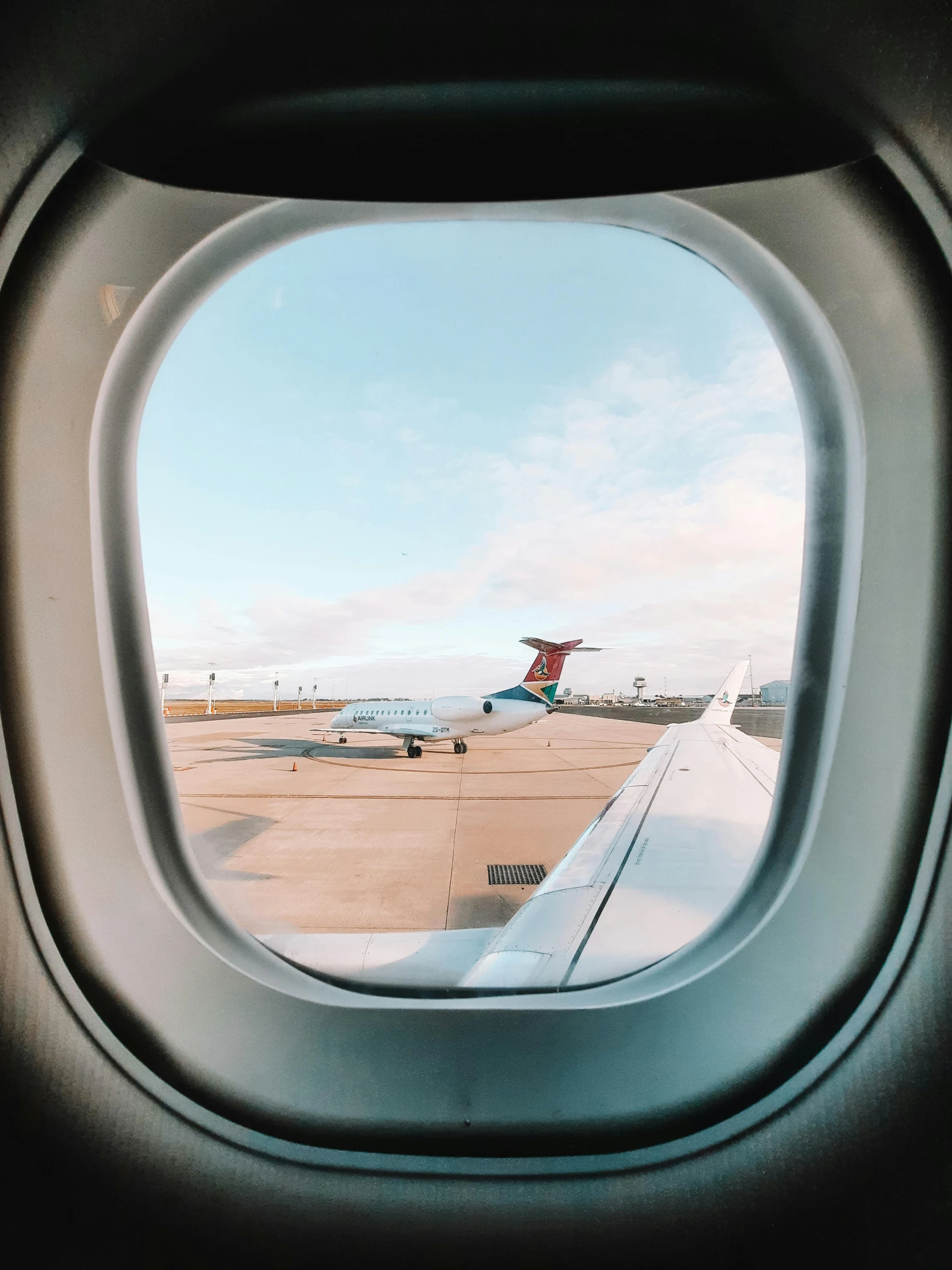 a view out of an airplane window at an airport, pexels contest winner, 🚿🗝📝, portholes, thumbnail, on a landing pad