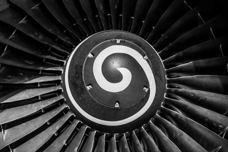 a black and white photo of a jet engine, by Glennray Tutor, pexels contest winner, spirals and swirls, cessna, symbol, circular shape