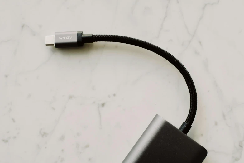 a close up of a cable connected to a device, by Carey Morris, pexels, vanta black, made of glazed, official product photo, vervia