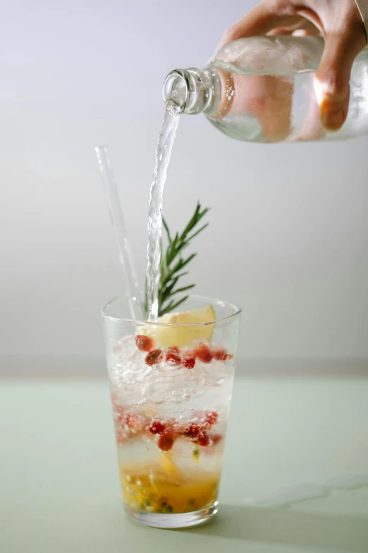 a person pouring a drink into a glass, with sparkling gems on top, square, pomegranade, f / 2 0