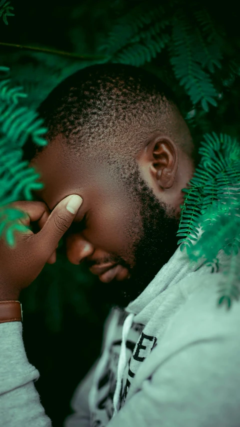 a man holding a cell phone to his ear, an album cover, by Chinwe Chukwuogo-Roy, trending on pexels, greenery, depressed mood, dark green, gray men