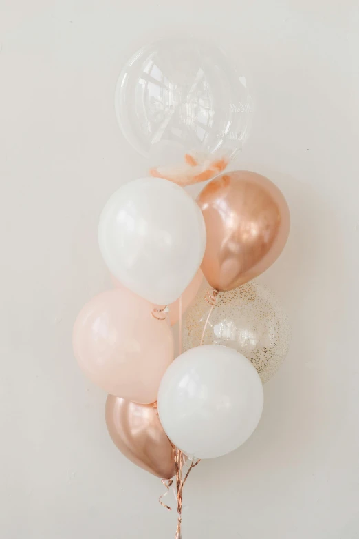 a bunch of balloons sitting on top of a table, rose gold, petite, multiple details, product shot