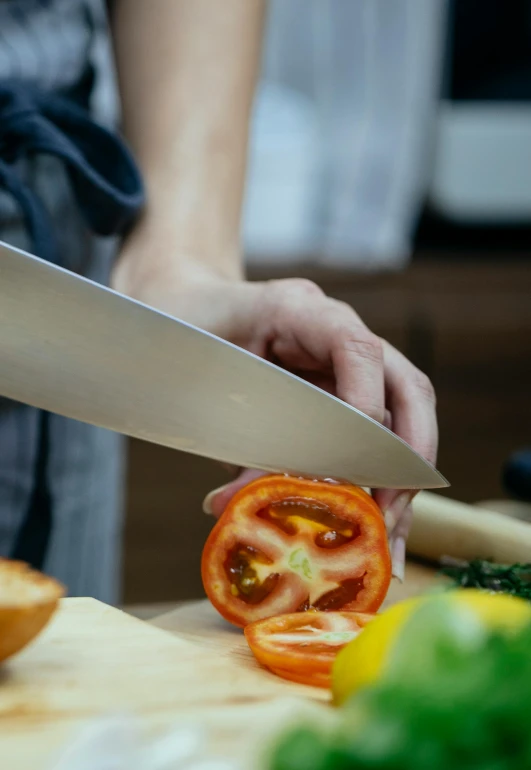 a person cutting a tomato on a cutting board, pexels contest winner, holding a kitchen knife, avatar image, chefs table, supersharp