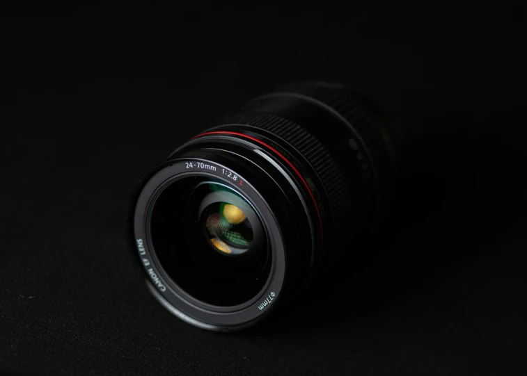 a close up of a camera lens on a black background, pexels contest winner, f/2.8l canon ef is lens, miniature product photo, high detailed photography red, [ realistic photography ]