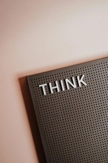 a black speaker with the word think written on it, by Robbie Trevino, trending on unsplash, brown and pink color scheme, panel, think in 3 d, thin