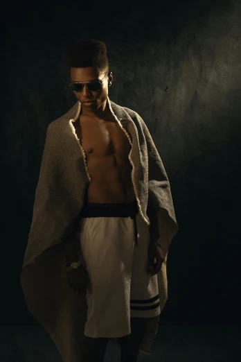 a shirtless man standing in a dark room, an album cover, inspired by Carlo Mense, unsplash, renaissance, brown jedi robe, dark shades, white robes, wearing a towel