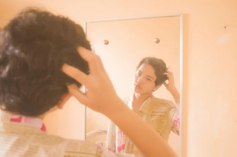 a woman combing her hair in front of a mirror, an album cover, inspired by Elsa Bleda, pexels, melanie martinez, still from a wes anderson movie, ignant, light skin