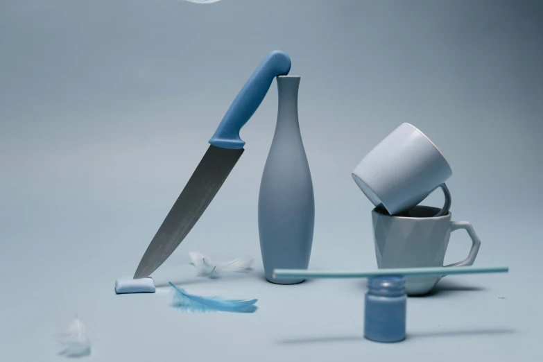 a knife sitting on top of a table next to a cup, a still life, trending on cg society, plasticien, grey and blue theme, toothpaste blast, high quality product image”, pastel overflow