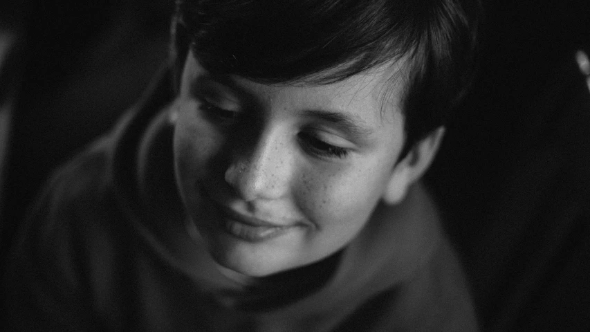 a black and white photo of a young boy, pexels contest winner, hurufiyya, boy has short black hair, smiling softly, andrey tarkovsky, (beautiful) girl