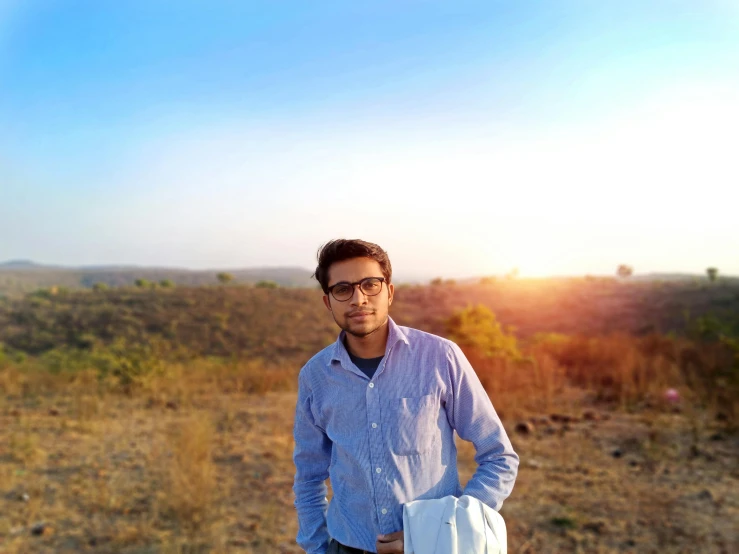 a man standing on top of a dirt field, a picture, inspired by Saurabh Jethani, romanticism, wearing a light shirt, avatar image