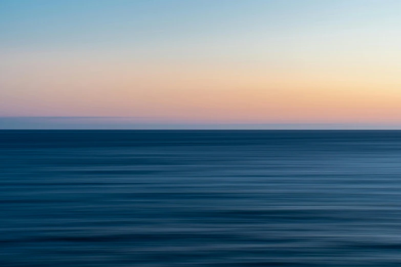 a blurry photo of the ocean at sunset, a minimalist painting, by Andrew Geddes, unsplash, minimalism, thick blue lines, horizont, multicoloured, mediterranean