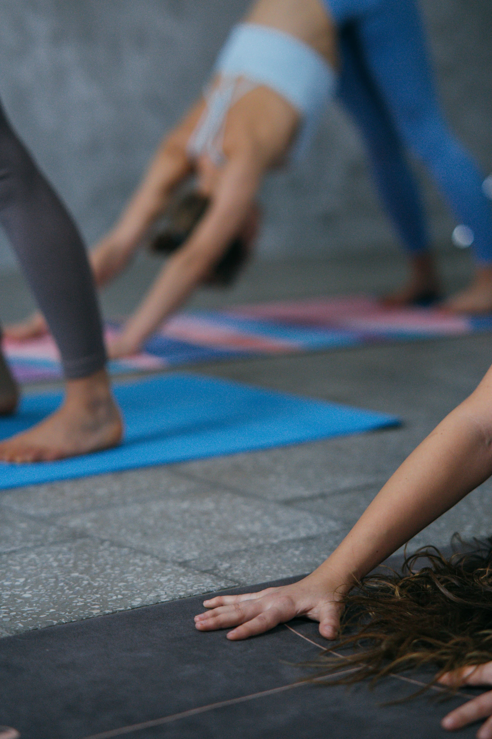 a group of people doing yoga together, zoomed in, thumbnail, promo image, head down