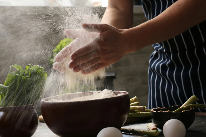 a person sprinkling flour into a bowl of food, inspired by Li Di, unsplash, fan favorite, avatar image, chef table, natural hands and arms