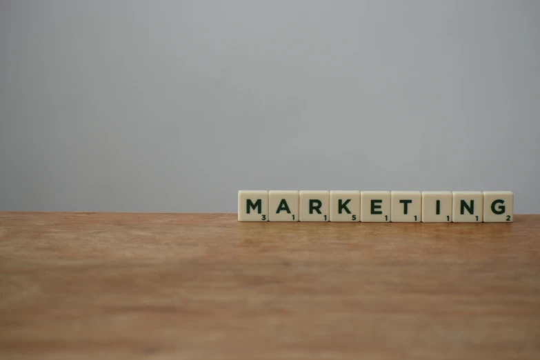 a wooden block spelling marketing on a table, by Emma Andijewska, trending on pexels, photorealism, animation, 3 4 5 3 1