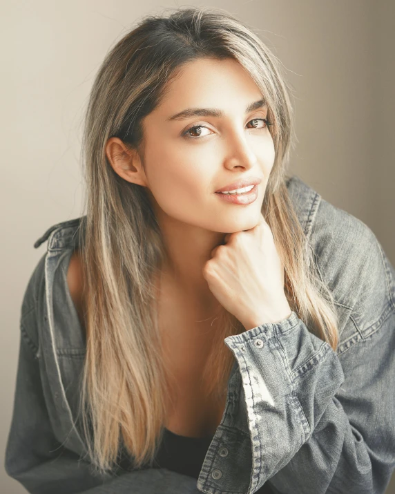 a beautiful young woman posing for a picture, by Arabella Rankin, wearing a grey hooded sweatshirt, beautiful tan mexican woman, diffused natural skin glow, ana de armas