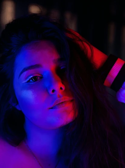 a close up of a woman with long hair, inspired by Elsa Bleda, trending on pexels, red and blue neon, bisexual lighting, instagram post, leds