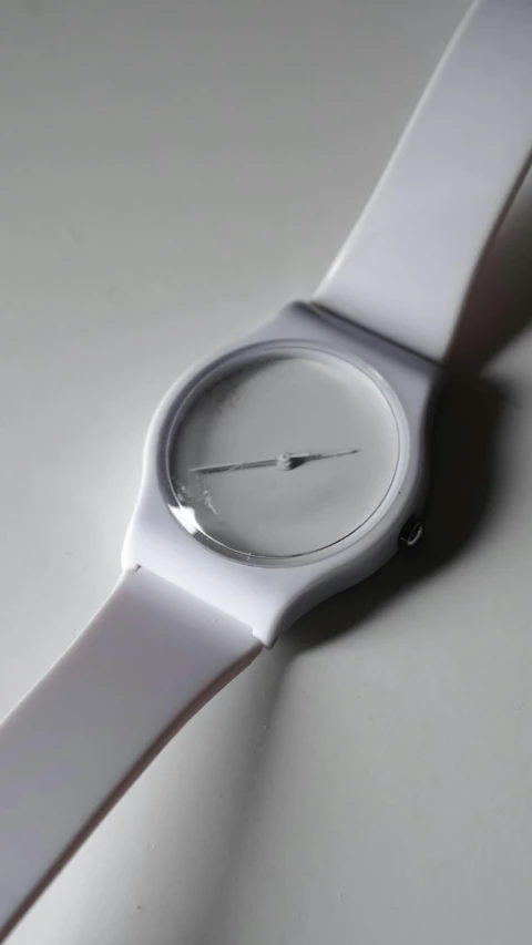 a close up of a wrist watch on a table, by Doug Ohlson, minimalism, white holographic plastic, ffffound, silicone skin, thumbnail