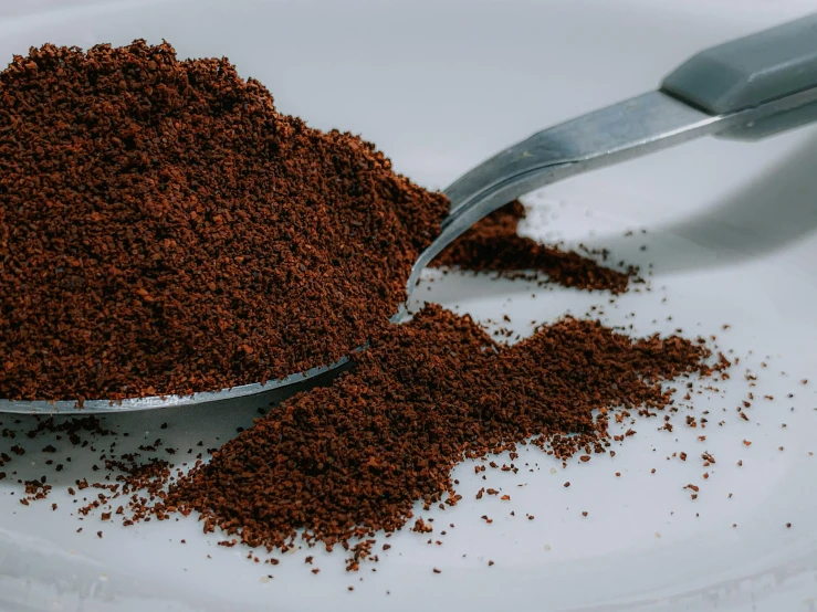 a spoon full of ground coffee on a plate, a stipple, trending on pexels, paprika, thumbnail, brown skin like soil, stacked image